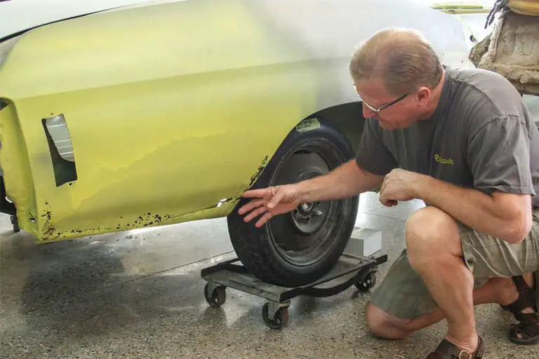 man looking at car for Car Restoration