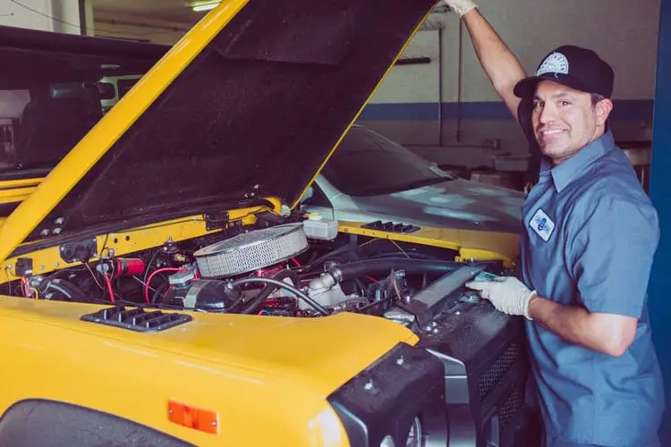 mechanic holding the car engine panel