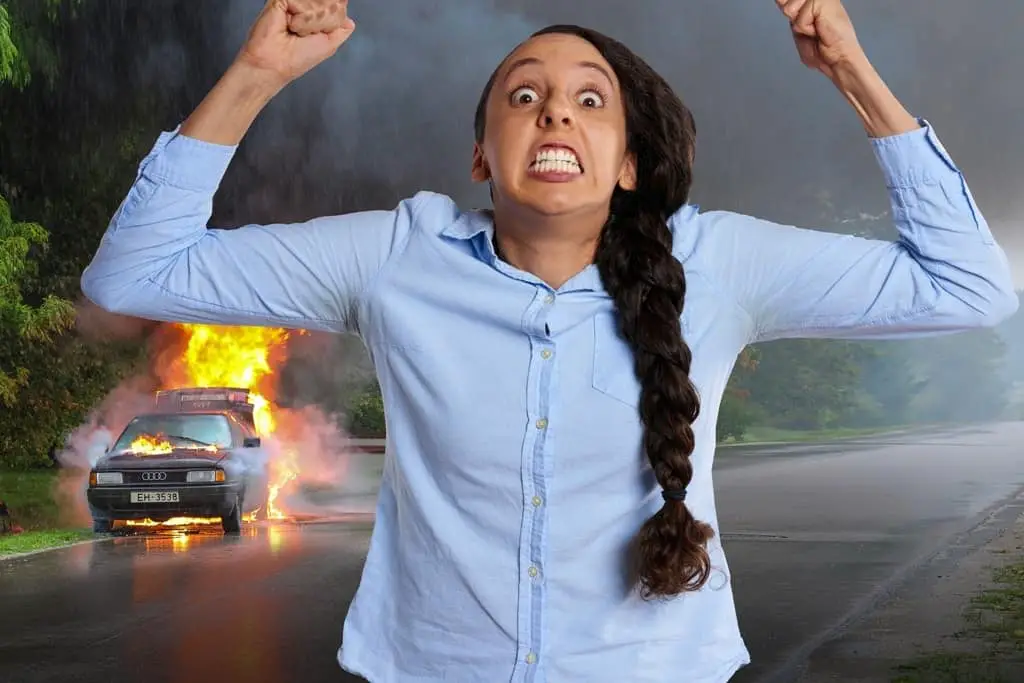 an angry woman with a burning car on her background