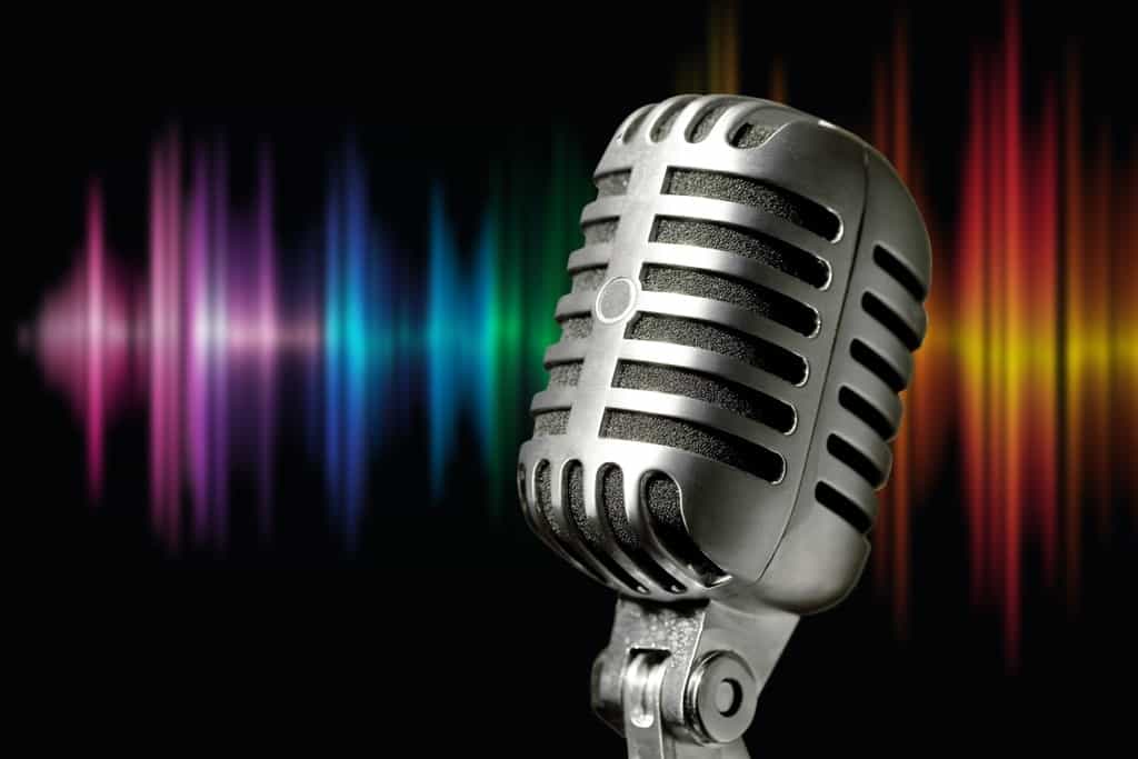 a silver classic microphone with rainbow Sound Waves on its backdrop