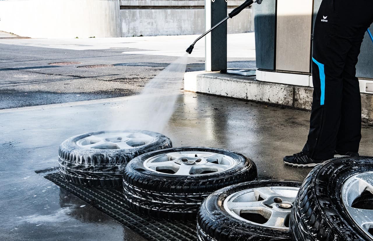 Man cleaning a bunch of tires